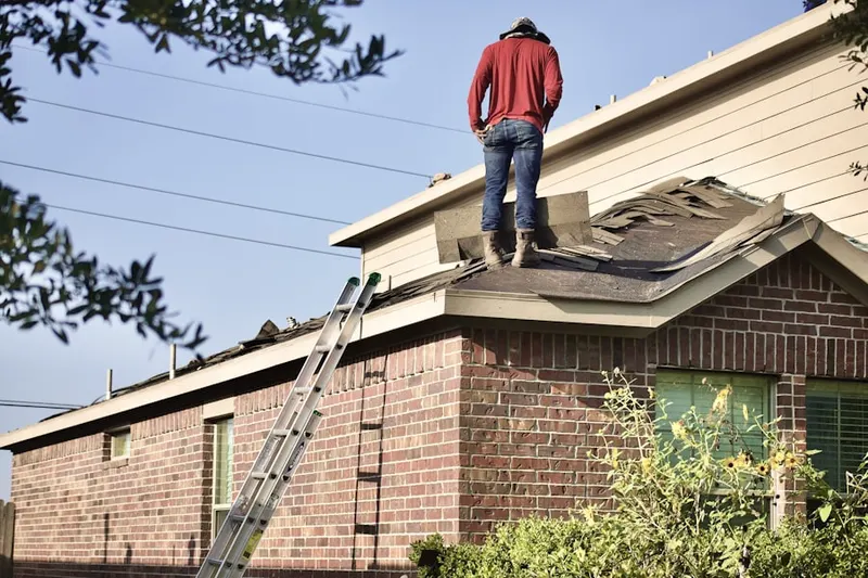Professional roofer working on a residential roof in Civic Center